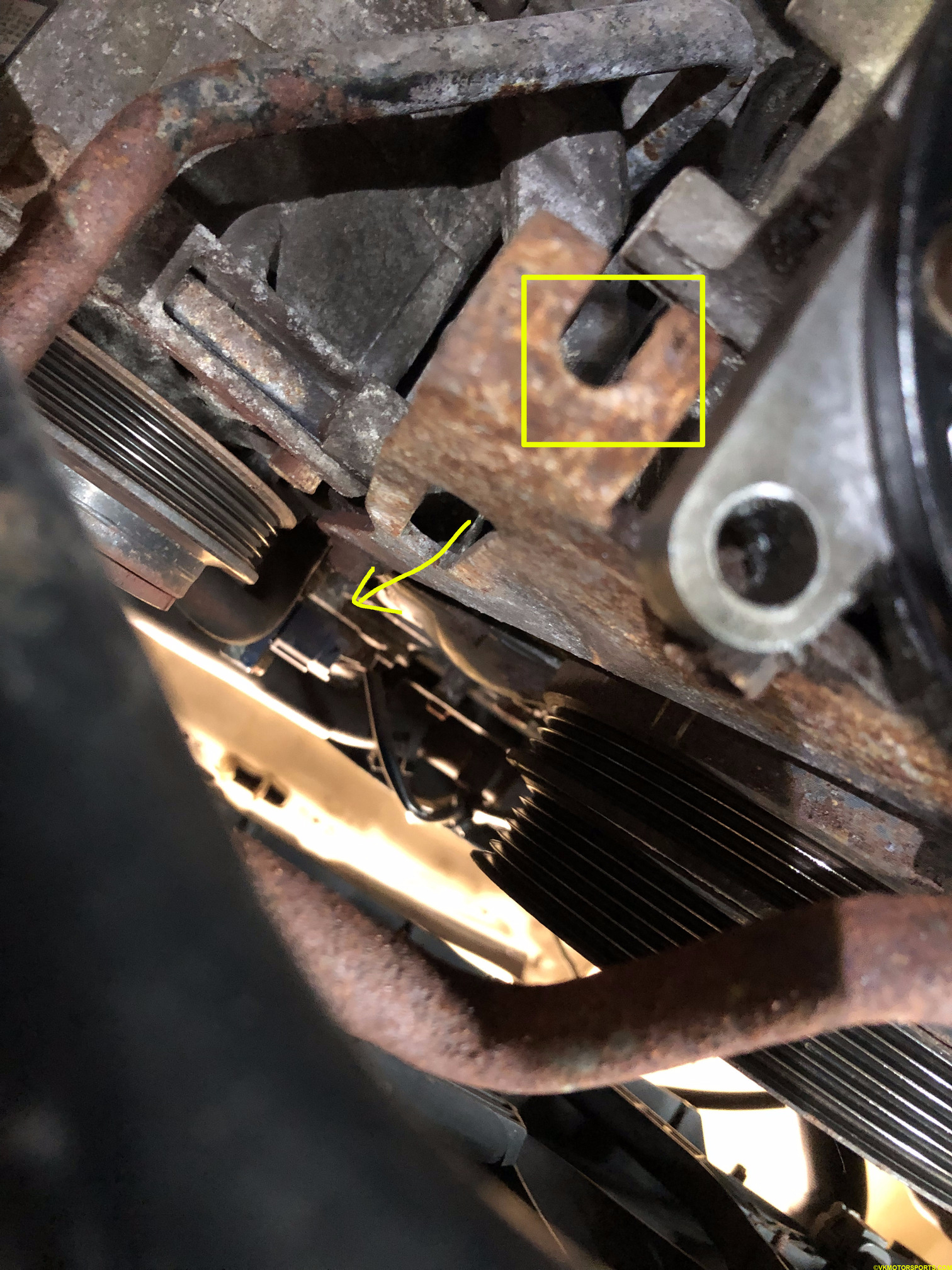 Figure 21. Location of the AC idler pulley shaft and adjuster bolt