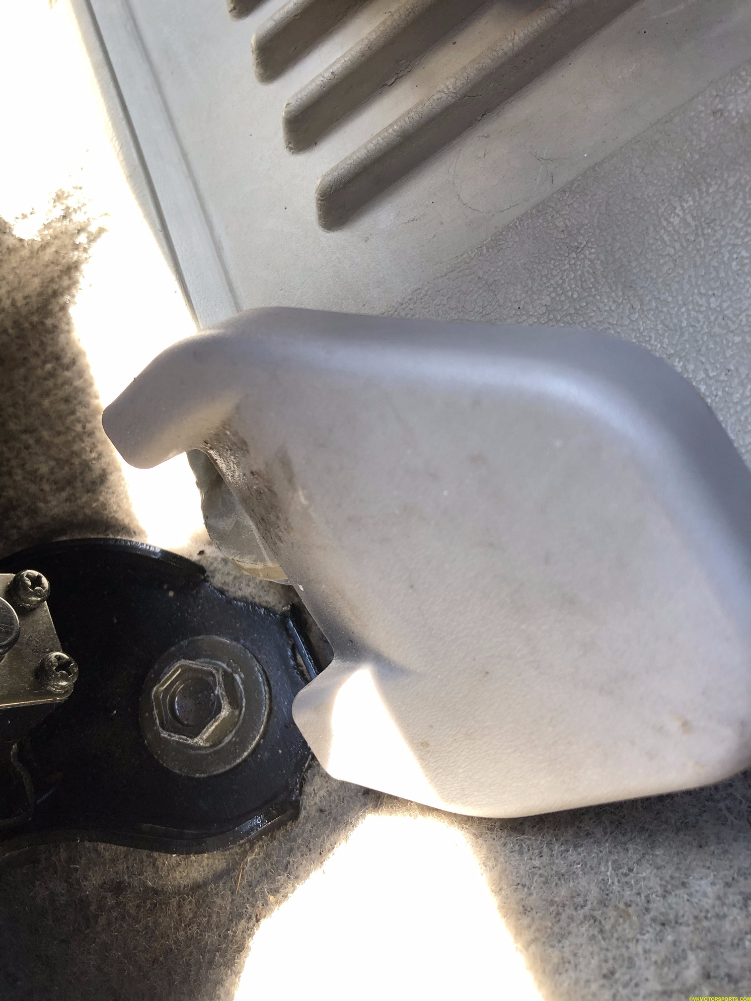 Figure 1a. Remove the bolt covers in the front of the seat