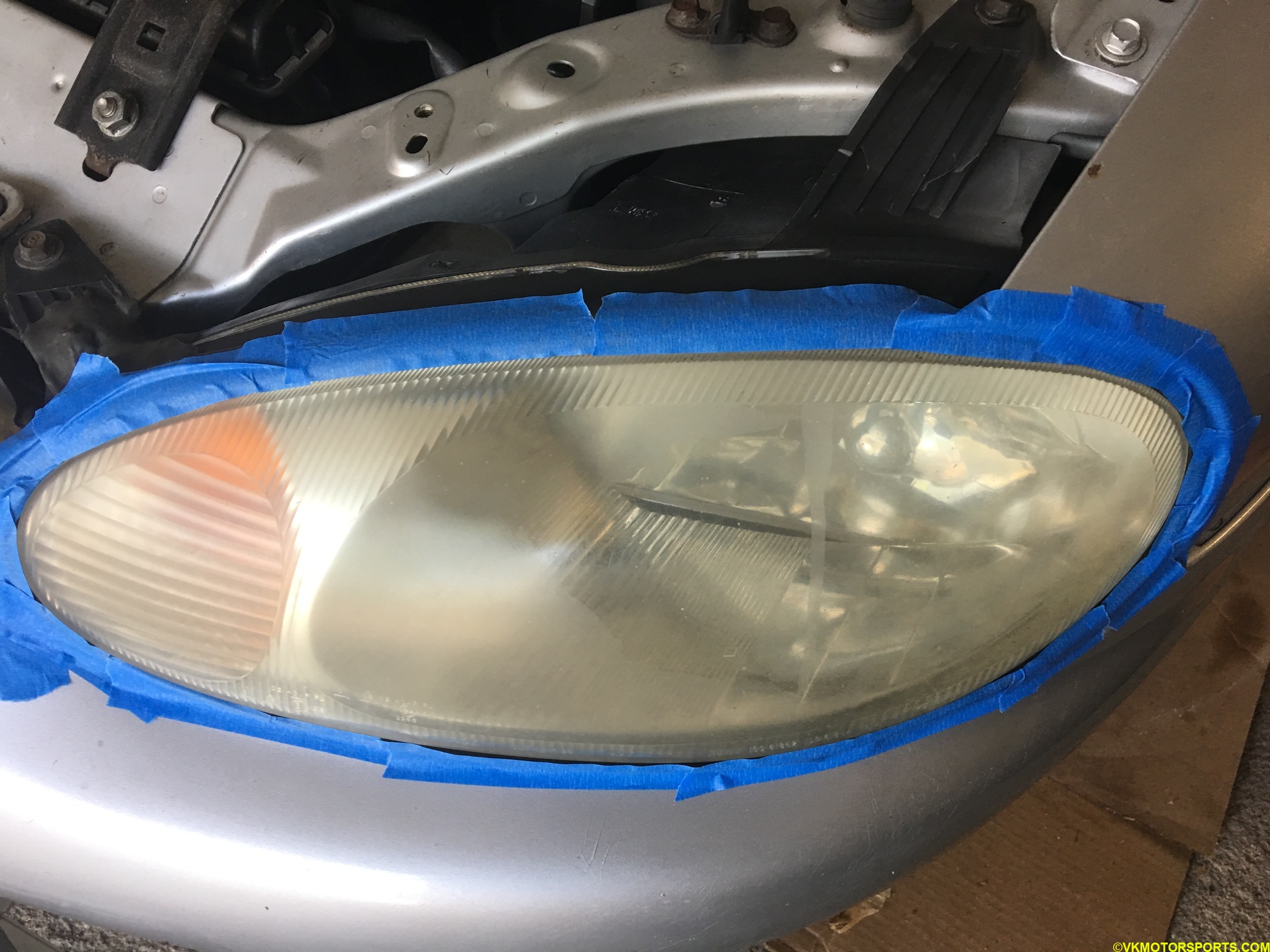 Driver-side headlight with masking tape