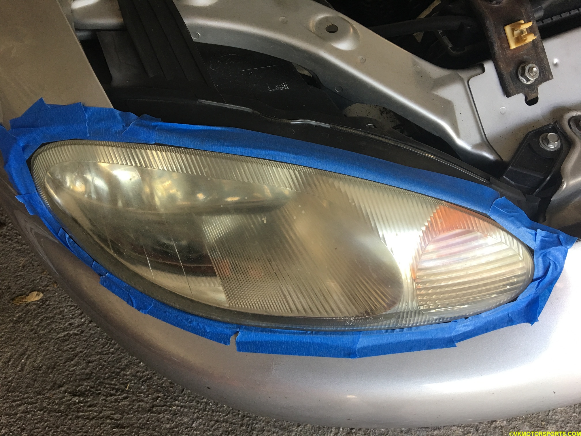 Passenger-side headlight with masking tape