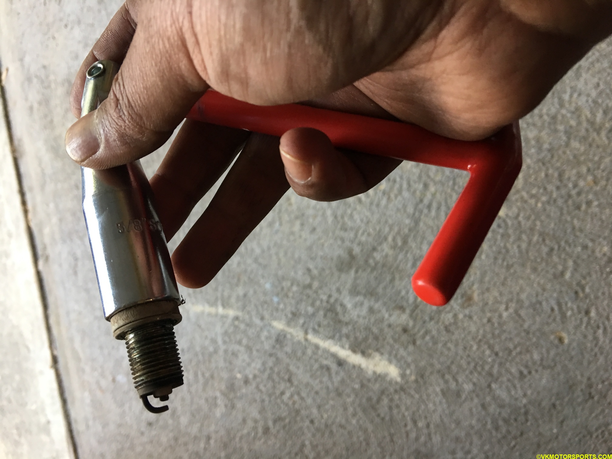 close-up of spark plug removal tool