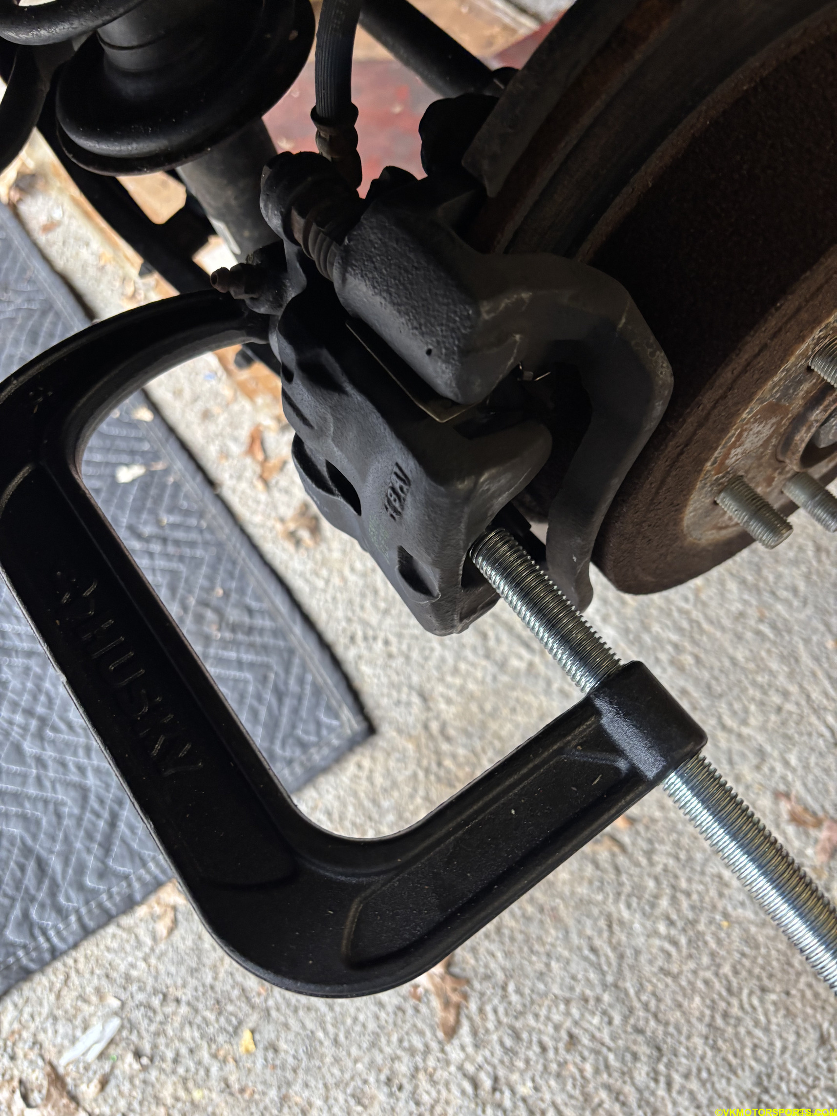 Figure 14. Press the caliper cylinders in place with a C-clamp