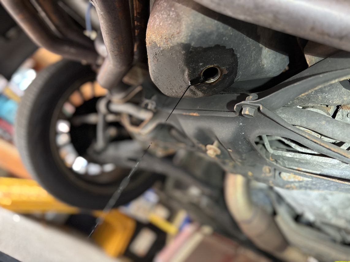 Figure 5. Oil drain bolt removed and oil draining